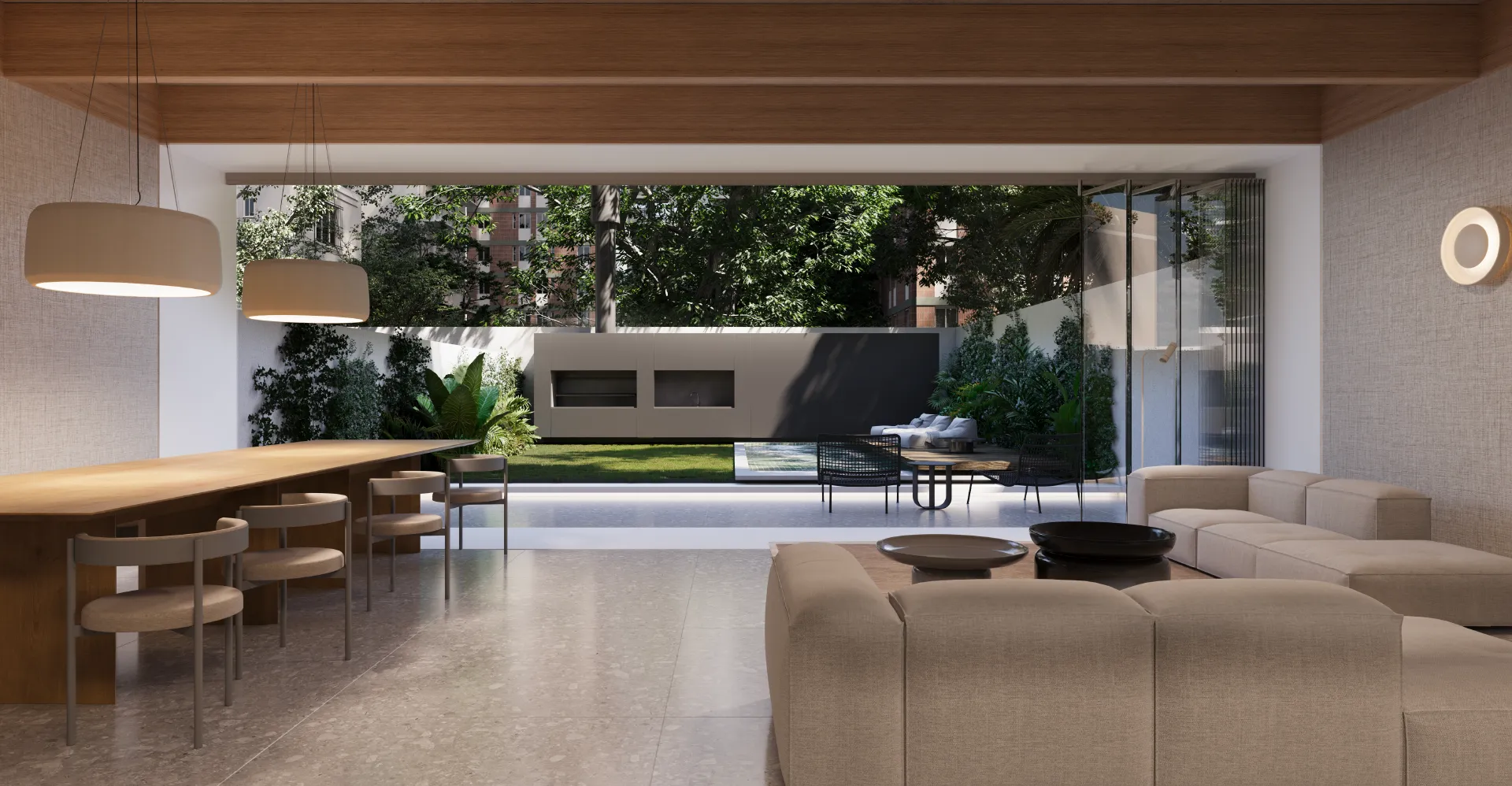 Espacio lounge en Hábita Freire, con un diseño abierto que conecta el interior con el jardín privado. El ambiente cuenta con un comedor elegante, cómodos sillones y una vista despejada hacia la piscina y la zona verde exterior. La decoración moderna y los grandes ventanales crean una atmósfera acogedora y luminosa, ideal para relajarse y disfrutar de la naturaleza