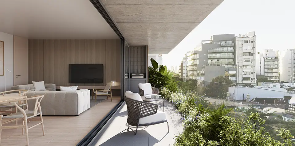 Balcón amplio y luminoso en el emprendimiento Hábita Freire, con vista despejada a la ciudad. El diseño contemporáneo se integra con el interior del living a través de puertas corredizas de vidrio, creando un espacio fluido y abierto. La vegetación en la terraza añade frescura y conexión con la naturaleza en un entorno urbano